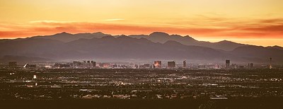 Las Vegas skyline at dusk with mountains in the background