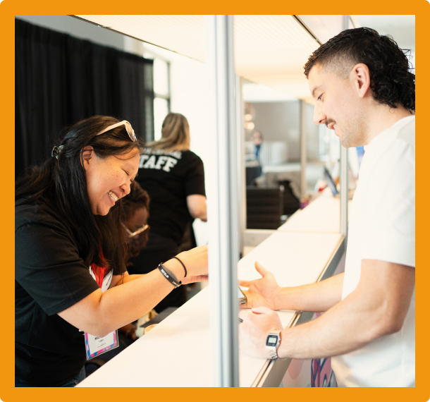 Two people registering for the conference